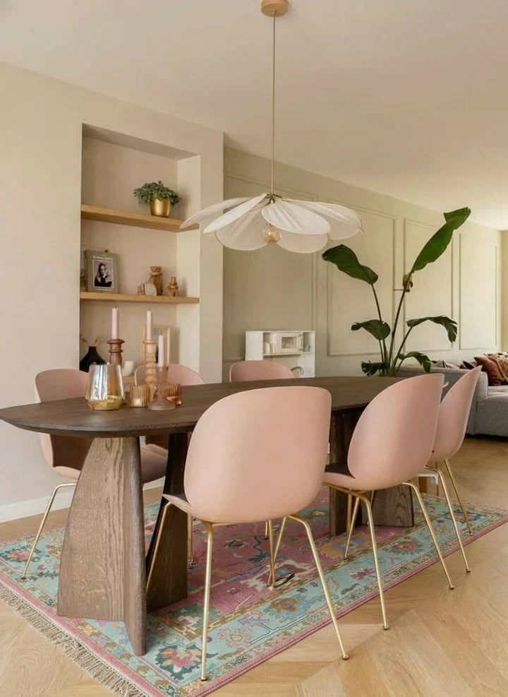 Oushak area rug in soft pink and blue tones styled under a dining table, hand-knotted Turkish rug by Bisha Rugs