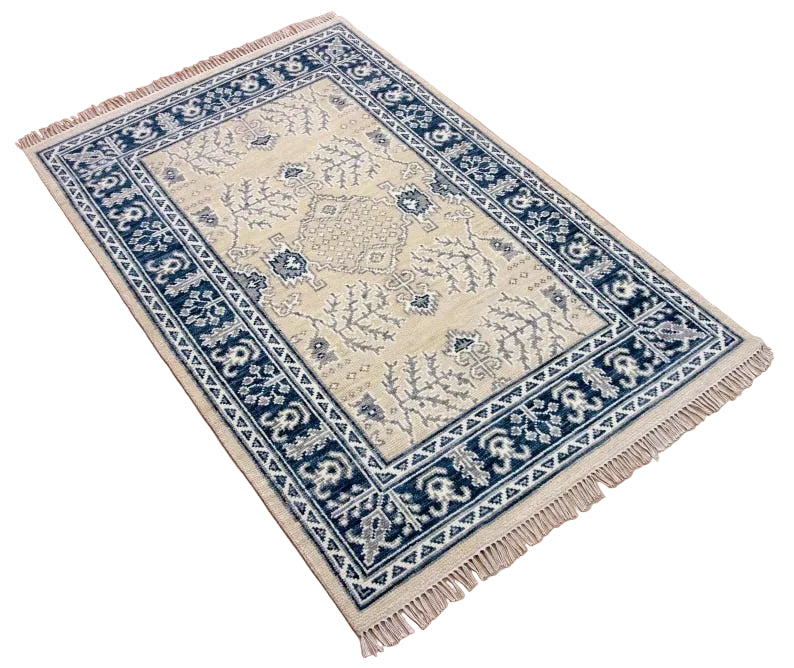 Decorative rug with blue and beige pattern on a wooden floor